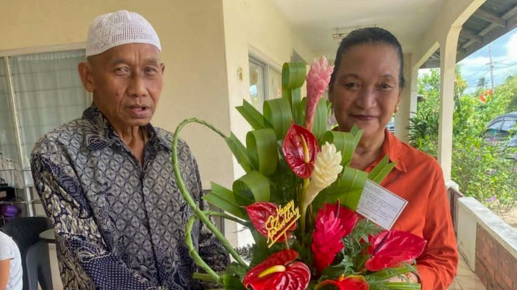 Asmoredjo-Doerijat couple celebrates 50th wedding anniversary surrounded by family and officials in Suriname.