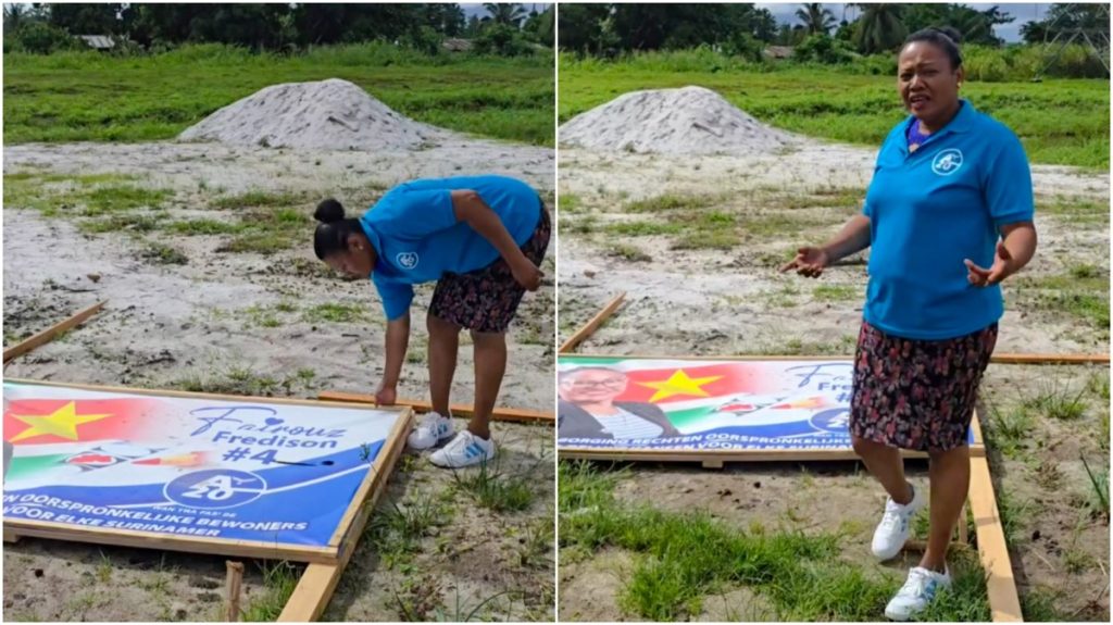 Beschadigd billboard van DNA-kandidaat in Suriname, campagne verstoord door vandalisme en politieke spanningen.