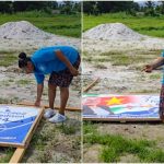 Beschadigd billboard van DNA-kandidaat in Suriname, campagne verstoord door vandalisme en politieke spanningen.